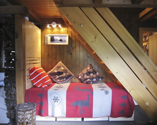 Reading corner and daybed under stairs